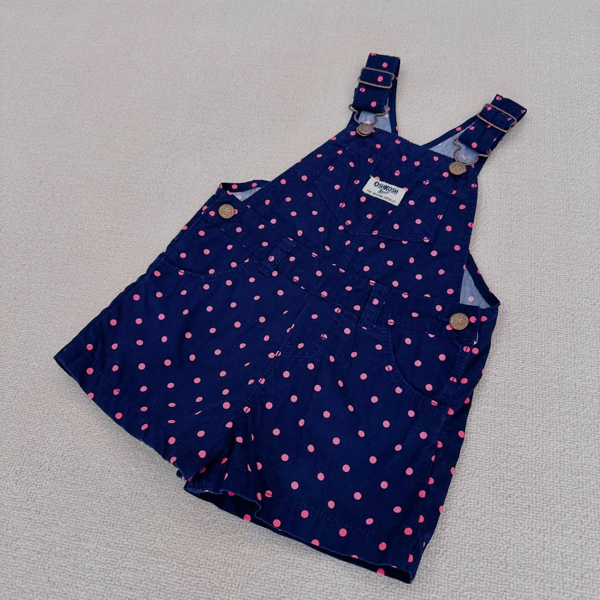 OshKosh B'gosh navy corduroy overalls with pink polka dots