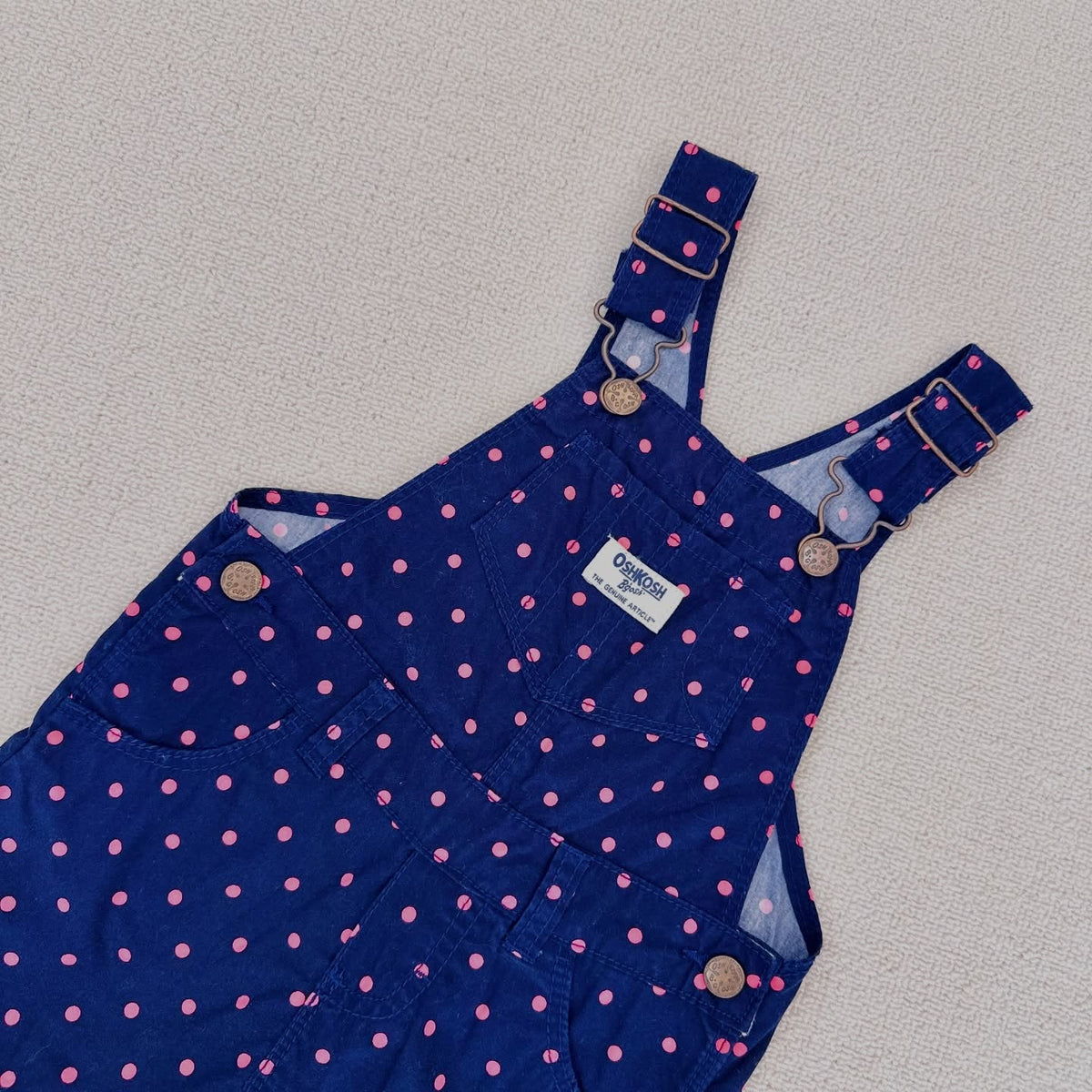 OshKosh B'gosh navy corduroy overalls with pink polka dots