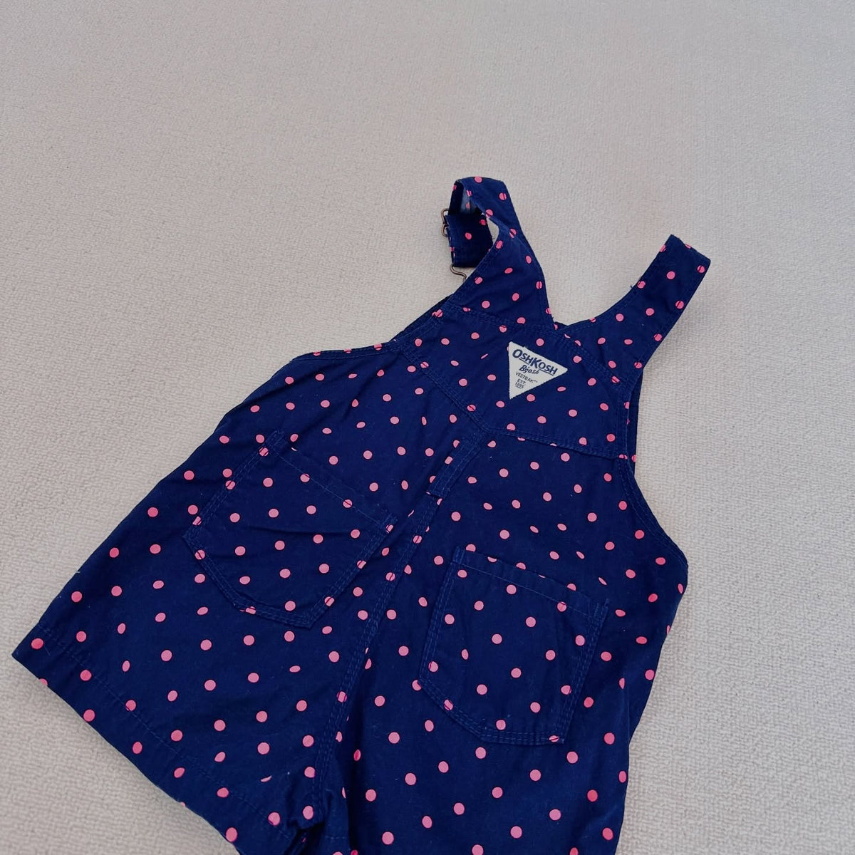 OshKosh B'gosh navy corduroy overalls with pink polka dots